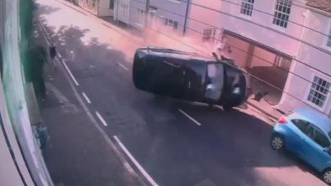 Crashing car on its side.