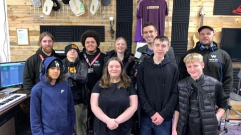 A group picture of students and Antony Baker in a studio. 