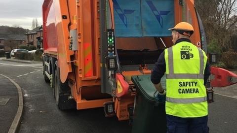 Bin collector in high-vis jacket