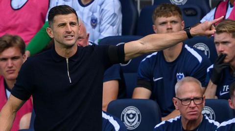 John Mousinho on the touchline