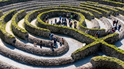 An aerial view of Kerdroya with people walking through the labyrinth