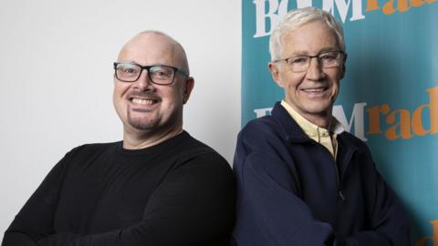 producer Malcolm Prince (left) and Paul O'Grady as he hosted a one off Easter Sunday radio show on Boom Radio, almost a year on from his departure from Radio 2