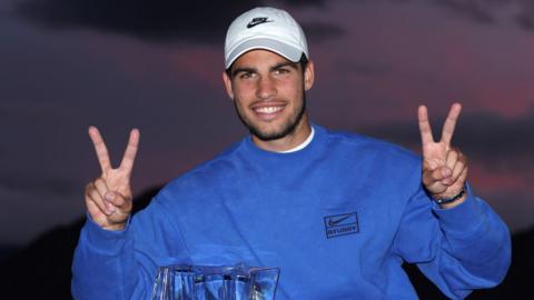 Carlos Alcaraz celebrates with the Indian Wells trophy