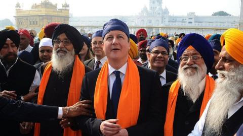 ritish Prime Minister David Cameron (C) along with Punjab State Chief Minister Parkash Singh Badal (2L), and Shiromani Gurdwara Parbandhak Committee (SGPC) President Avtar Singh Makkar (2R) visit the Sikh Shrine Golden temple in Amritsar on February 20, 2013