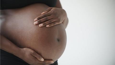 Stock photo of a pregnant woman's belly