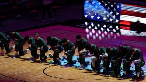 Boston Celtics players kneel during the national anthem before their game with the Miami Heat on 6 January