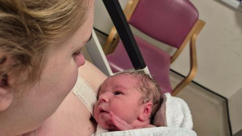 Abbie Foord holding her new-born baby