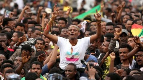 Protestors gesture in front of federal police officer during a protest following the burial ceremony of Simegnew Bekele EthiopiaÃ•s Grand Renaissance Dam Project Manager w