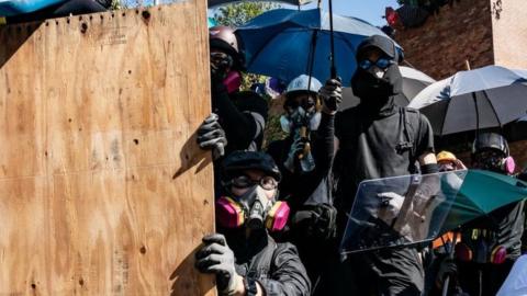 Protesters clash with police as police fire teargas at them at the Hong Kong Poytechnic University