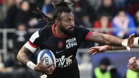 Toulon's Fijian outside centre Waisea Nayacalevu (L) hands off a change from Munster's Irish scrum-half Craig Casey (R) as he runs with the ball during the European Champions Cup rugby union match between Rugby Club Toulonnais (Toulon) and Munster at the Stade Mayol in Toulon, south-eastern France on January 13, 2023.