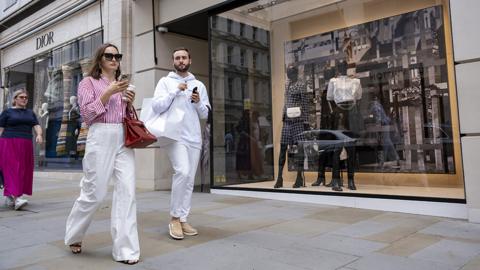 People walk down Bond Street