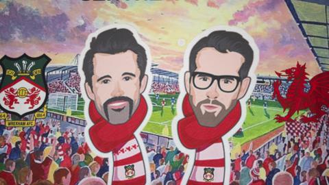 Ryan Reynolds and Rob McElhenney banner on display at the Racecourse