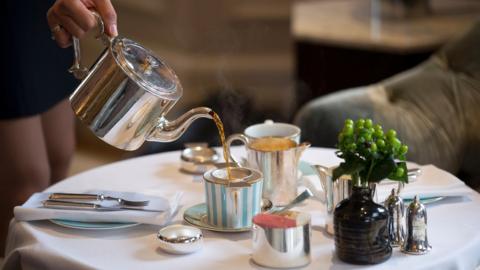 Person pouring tea