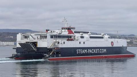 The Manannan ferry, which is white black and red and has 'Steam-Packet.com' written on the side, in Douglas Bay.