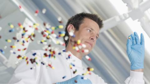 Pills being examined by a man