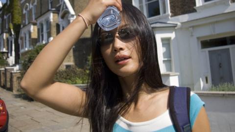 Woman trying to keep cool