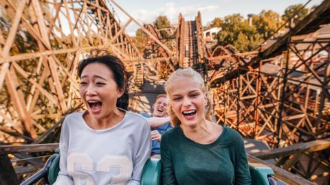 A stock image of riders on a rollercoaster