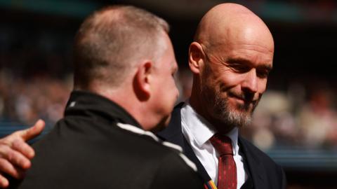 Manchester United boss Erik ten Hag pats Coventry manager Mark Robins on the shoulder