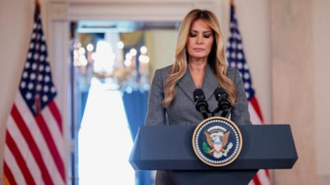 Melania at a podium