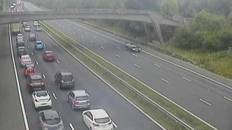 A traffic camera image of the M4, with traffic queueing along the road. 