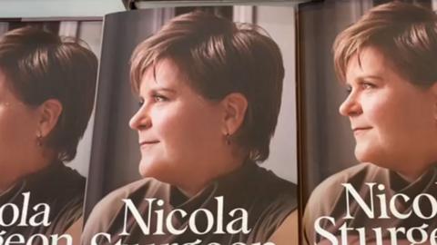 Three copies of Nicola Sturgeon's book 'Frankly' side by side. The cover shows her in profile looking to the left hand side, wearing a brown top.