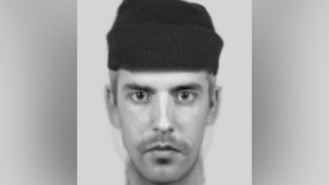 A black and white e-fit of a man wearing a black beanie hat. He is looking directly into the camera.
