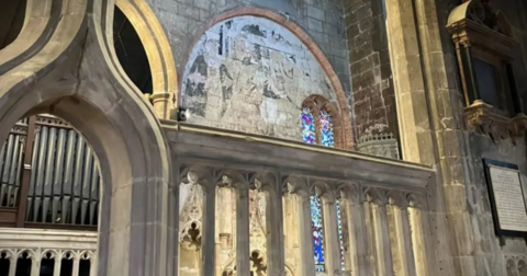 A medieval mural on a church wall 