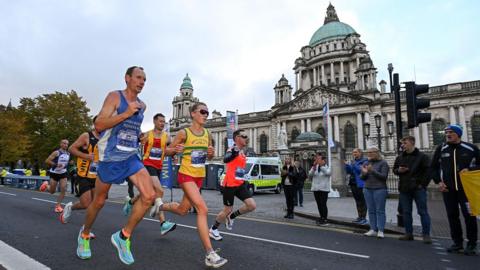 Runners pass Belfast City Hall. 