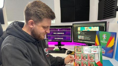 Jack White looks at his Euro 2024 sticker album