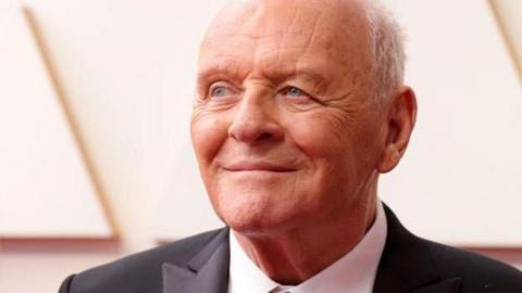 Anthony Hopkins wearing a dark suit and white collared shirt at the Oscars