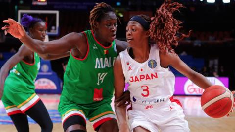 Stephanie Mawuli of Japan is challenged by Sika Kone of Mali