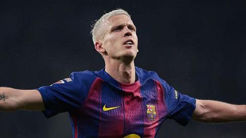 Dani Olmo celebrates scoring for Barcelona, with arms stretched out at his side