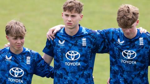 Rocky Flintoff stands with England U19s team-mates 