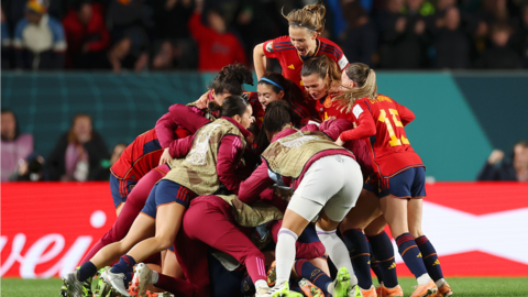 Spain's players celebrate scoring against Sweden
