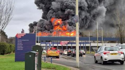 A fire where flames and huge plumes of smoke can be seen at an industrial estate in West Lothian