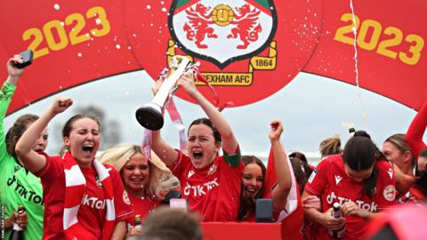 Wrexham players celebrate with the Adran North trophy