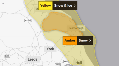 A Met Office map showing a yellow area on Yorkshire's coast covered by snow and ice warning, with a smaller area covered by a more severe amber weather warning.