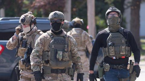 Federal law enforcement officers wearing masks in Illinois in October 2025. 