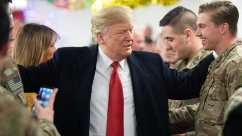 US President Donald Trump and First Lady Melania Trump greet members of the US military during an unannounced trip to Al Asad Air Base in Iraq on December 26, 2018