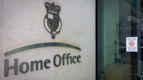 The Home Office logo on the exterior of a Home Office building