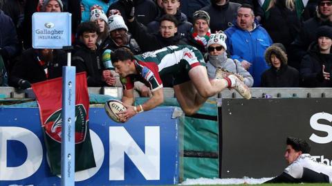 Adam Radwan, wearing the bottle green, red and white of Leicester Tigers dives to score their third try during the Gallagher PREM match between Leicester Tigers and Saracens at Mattioli Woods Welford Road.