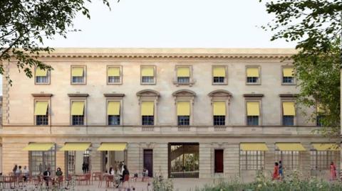 Artists impression of the new Fashion Museum building in Bath. It is a wide, beige building with lots of windows spanning the front. There are people walking around near it.
