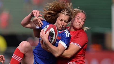 Kelsey Jones makes a tackle for Wales against France