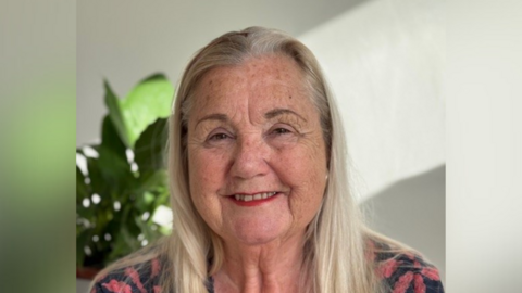 A head and shoulders image of Diane Perry-Yates. She is smiling and looking directly into the camera.