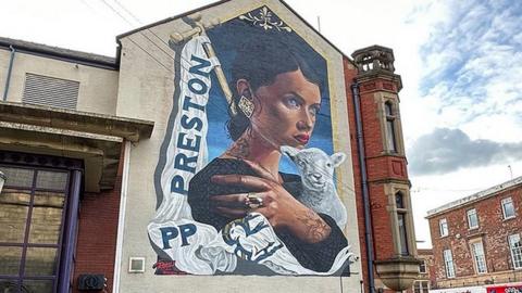 Mother mural on side of pub building