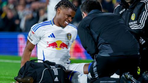 Largie Ramazani receives treatment from the medical team in the game against Watford