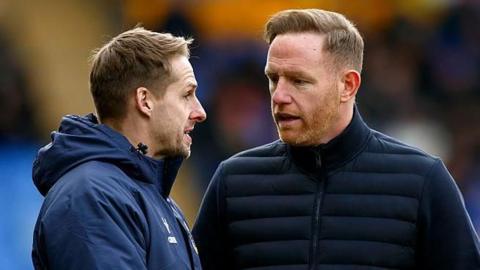 Dave Edwards on the left talks to Shrewsbury Town head coach Gavin Cowan during a game