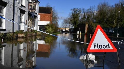 A sign warns of flooding in Tewkesbury, Gloucestershire