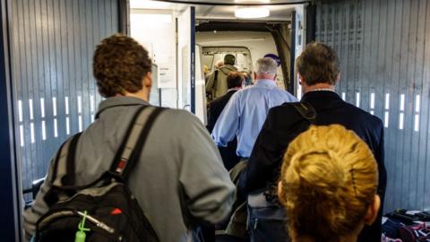 Passengers boarding a flight.