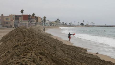Lifeguards keep watch around the beaches for the arrival of Hurricane Hilary in Long Beach, California